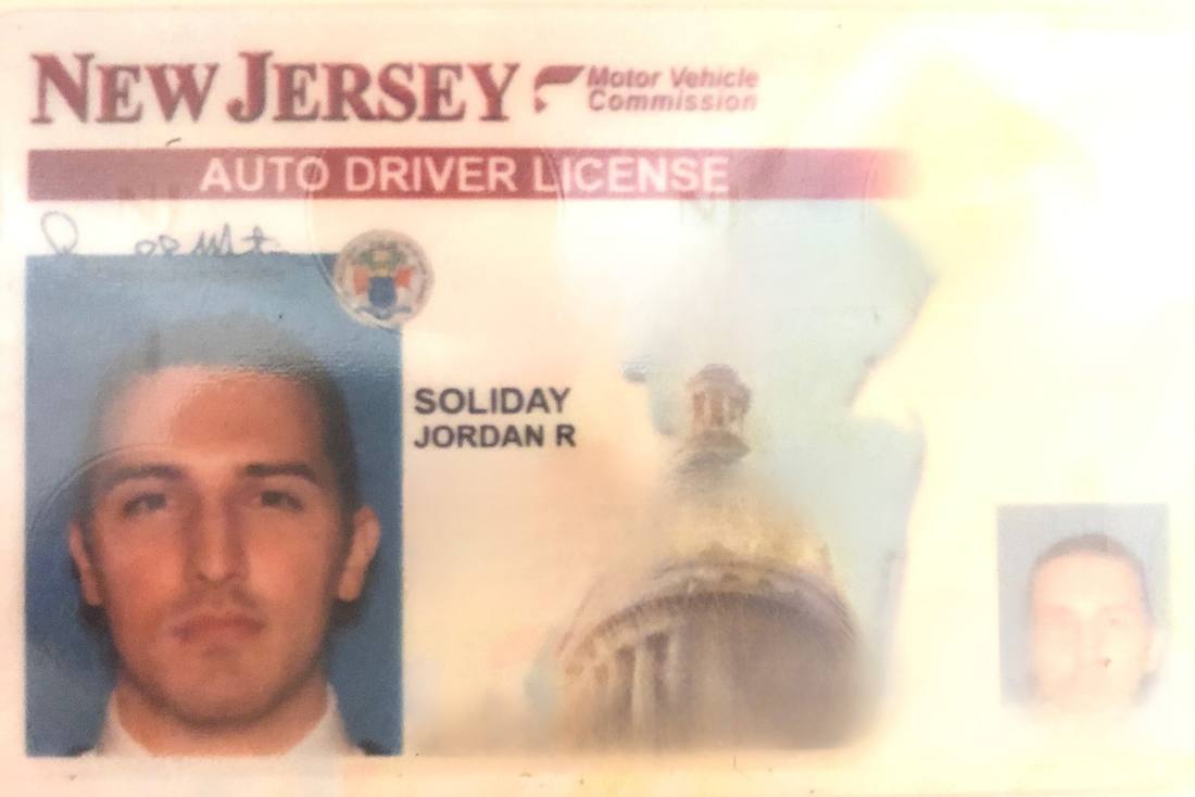 A faded New Jersey driver licence, buzzcut, unsmiling