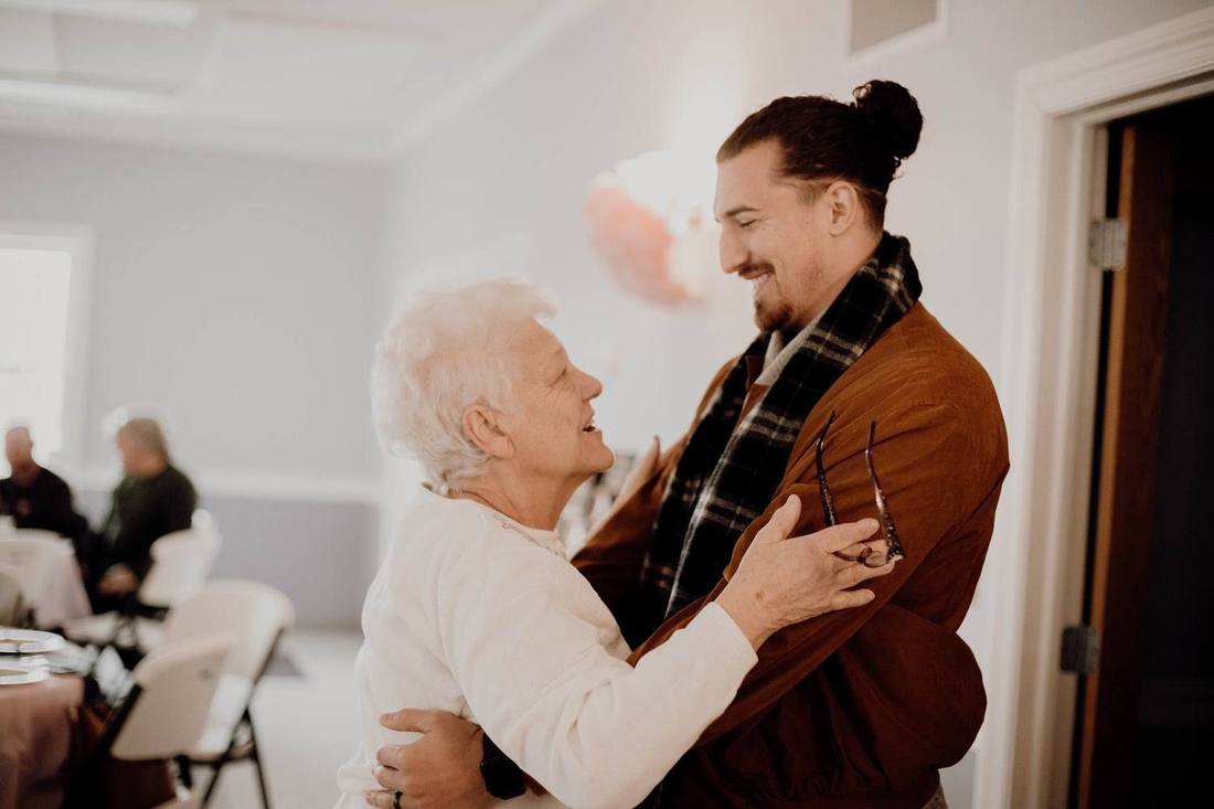 Embracing my grandmother, both of us laughing