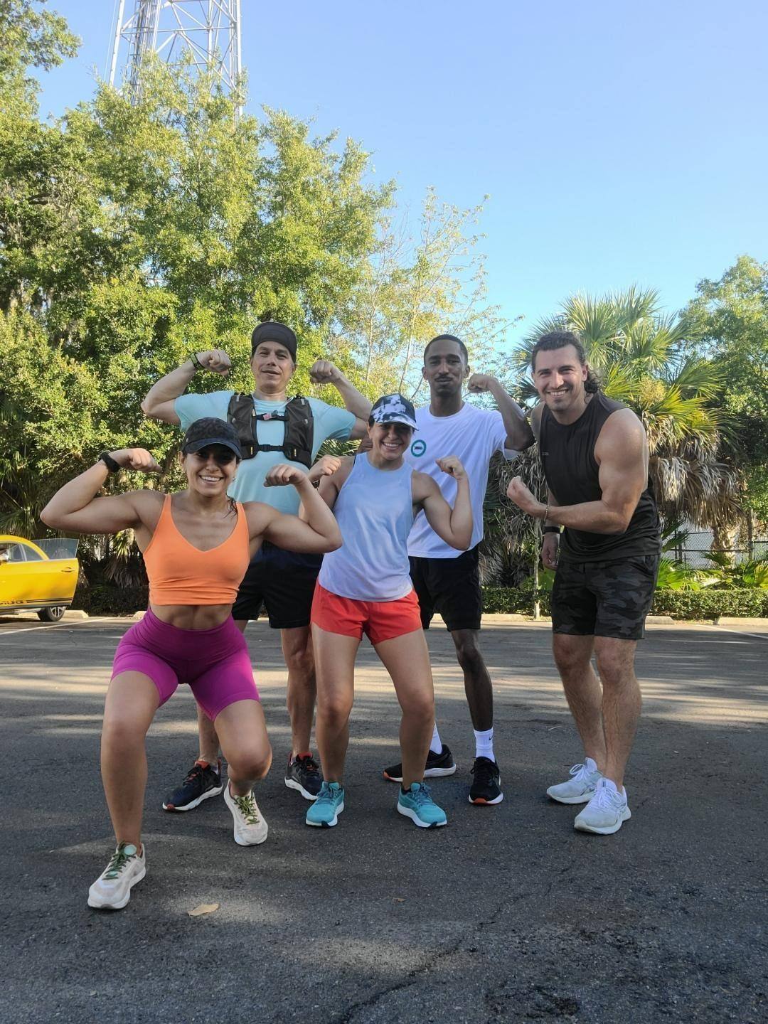 Five of us in a car park after a run, every one of us flexing