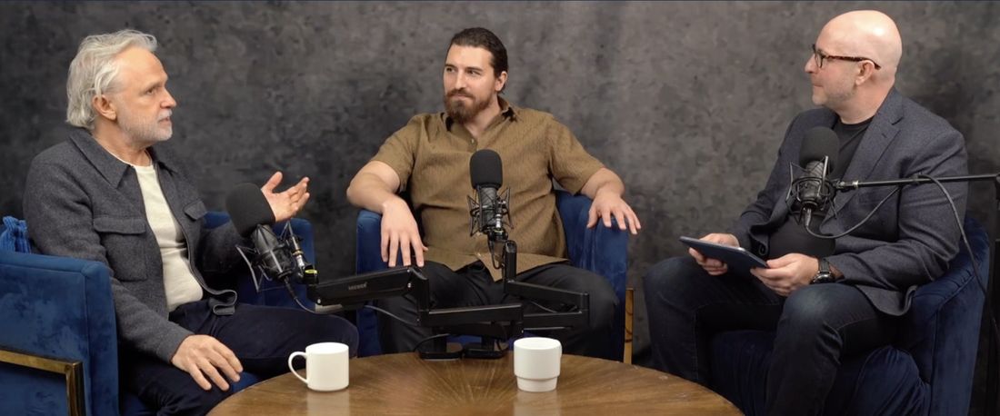 Samir and I with a host at a round table, three microphones between us